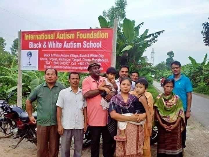 Families gathered at the International Autism Foundation Black & White Autism School signboard