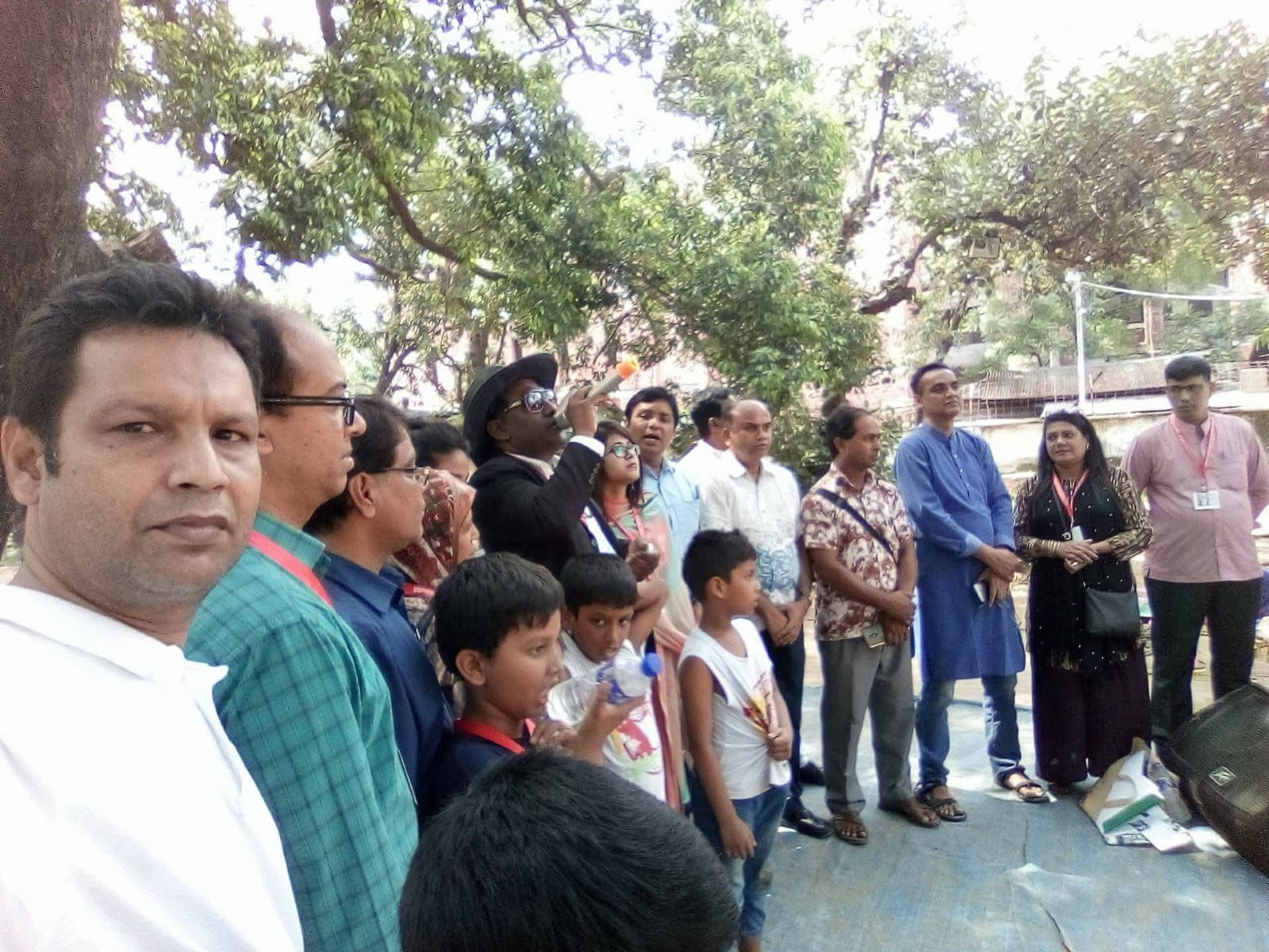 Community gathered under the trees at a Foundation advocacy meeting