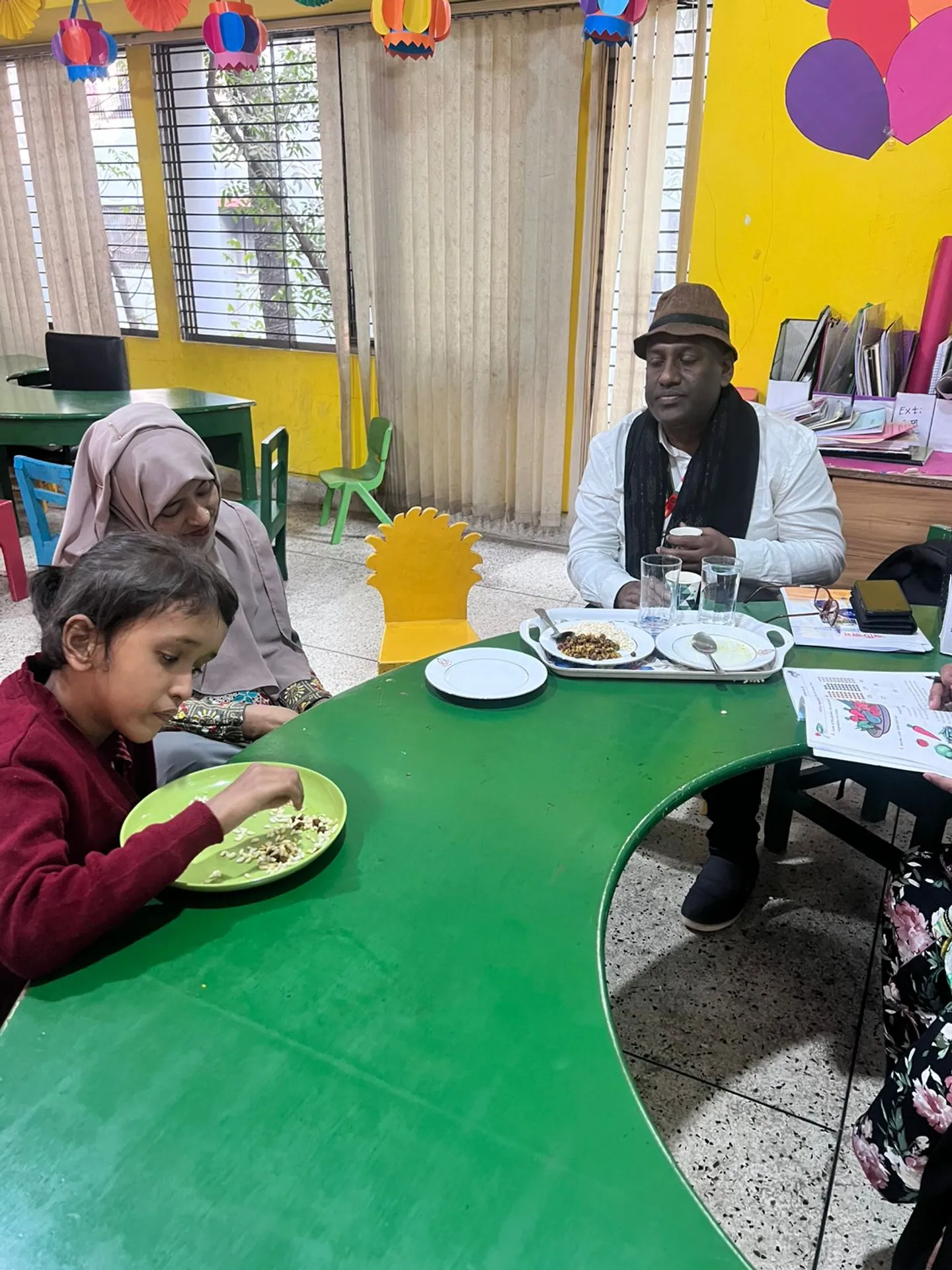 Child eating with chairman