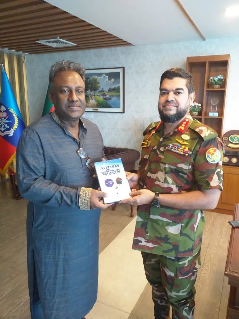 Presenting a copy of the book Autism to a uniformed officer