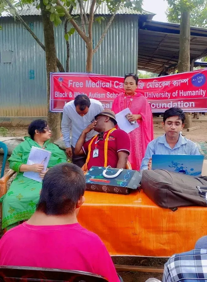 Doctors seeing patients at a table at the free medical camp