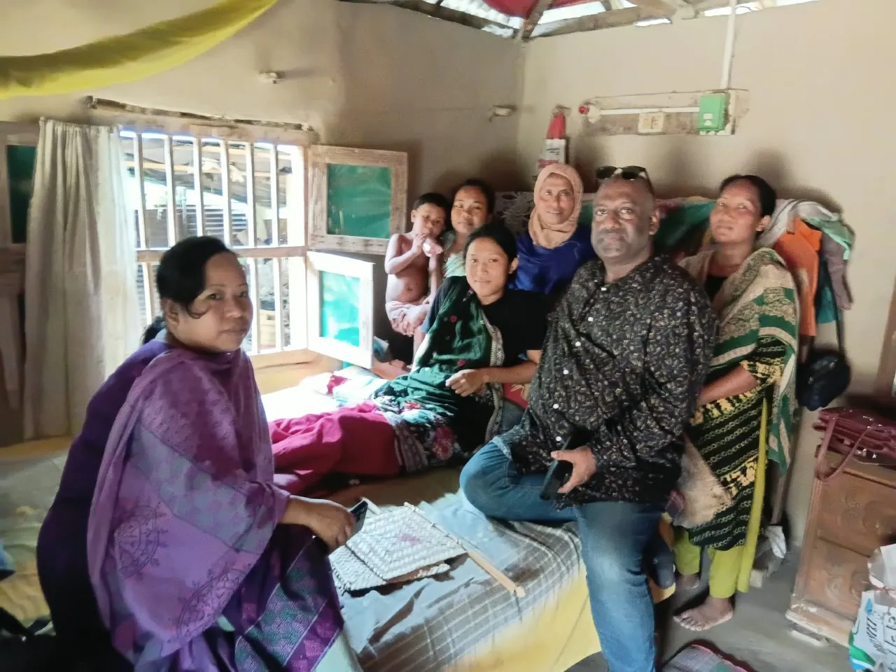 Sitting with a family indoors during a visit