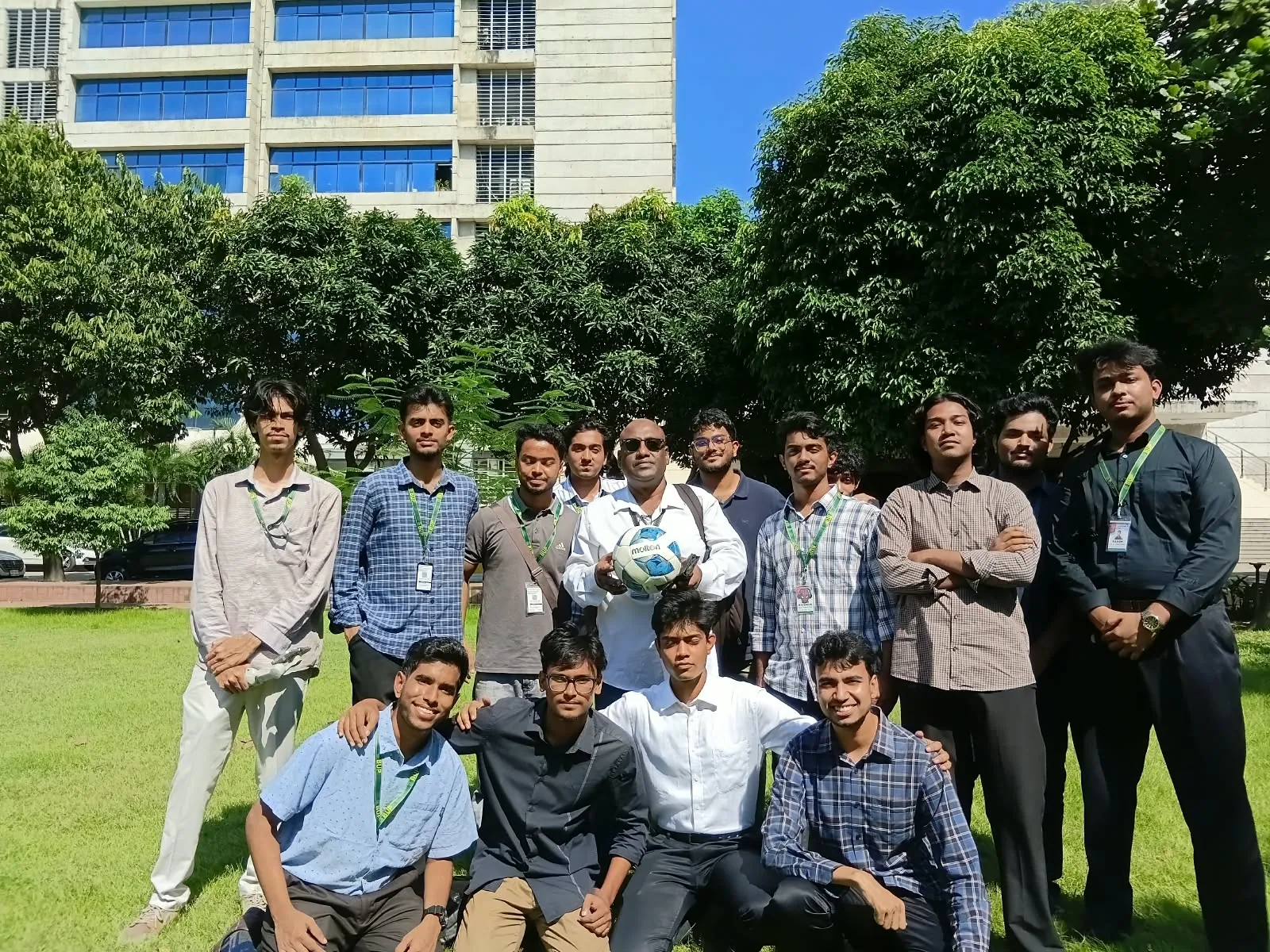 A group portrait of young men on a sunny lawn