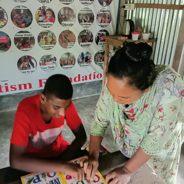 A teacher helping a boy trace letters