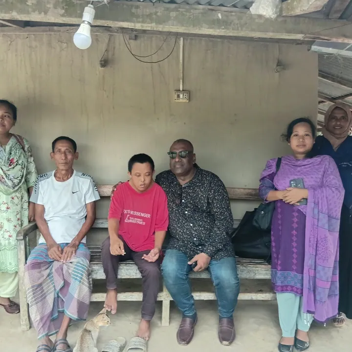 Sitting with a family on a veranda