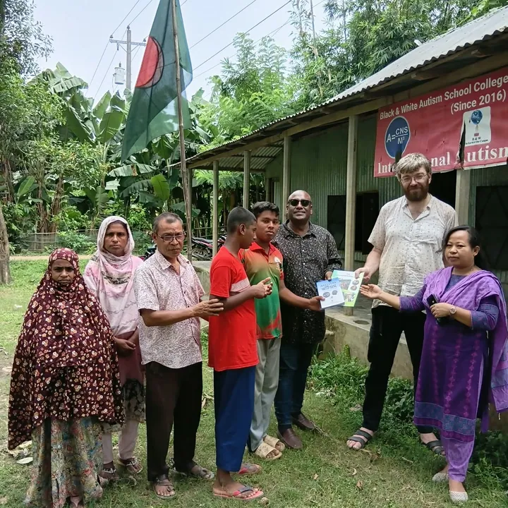 Villagers gathered under the national flag outside the school
